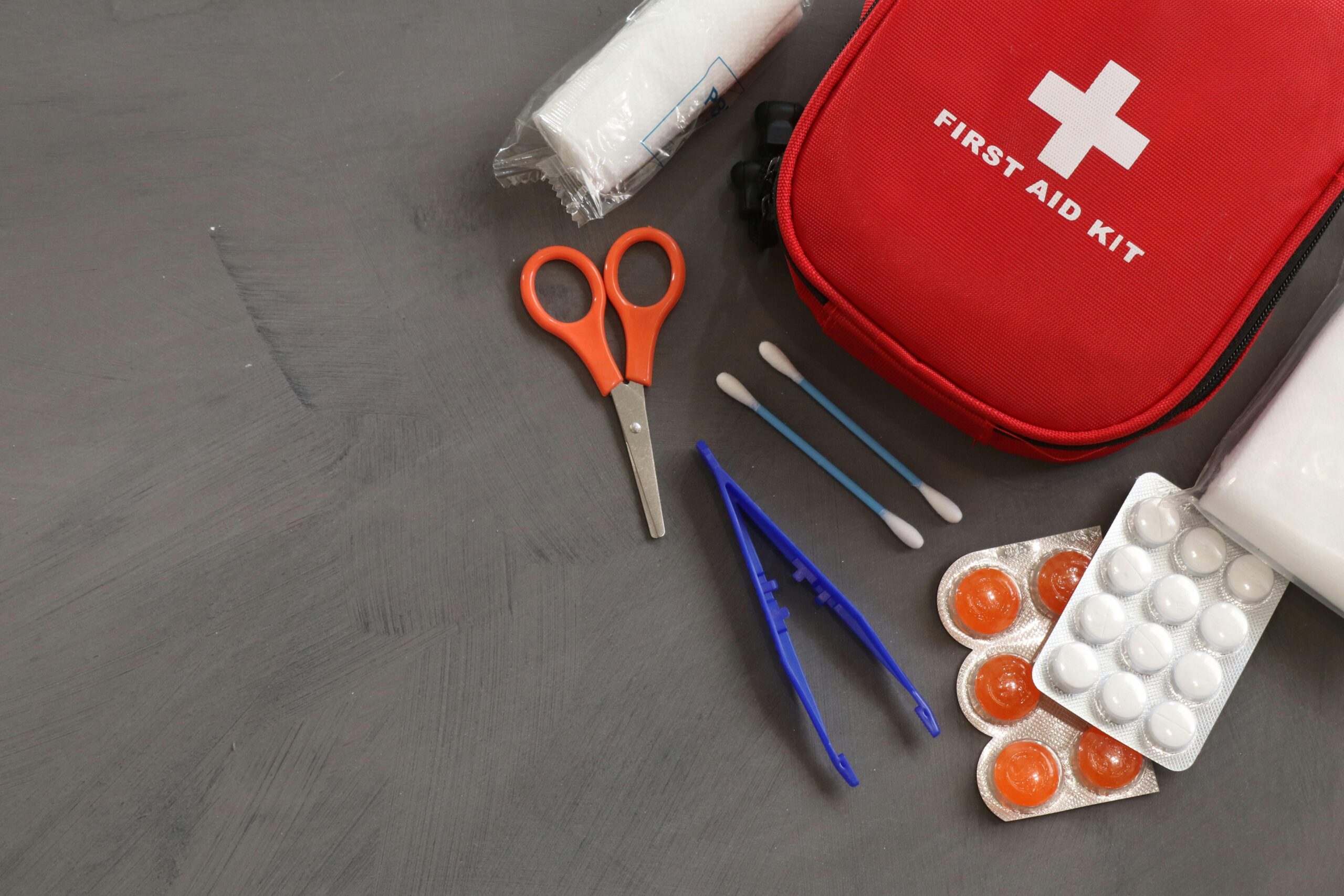 A comprehensive first aid kit with essential medical tools and supplies for emergencies.